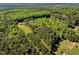 Expansive aerial view of a property with woods, fields, and a home, offering a secluded and rural setting at 7030 Shep Royster Rd, Oxford, NC 27565