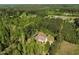 A beautiful aerial view showcases a charming home nestled amongst a lush green forest, creating a serene and private setting at 7030 Shep Royster Rd, Oxford, NC 27565