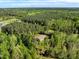 Aerial view of a home nestled in a lush, dense forest offering privacy and natural beauty at 7030 Shep Royster Rd, Oxford, NC 27565