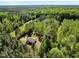 Aerial view showcasing a home surrounded by trees, with verdant greenery, and a rural, peaceful setting at 7030 Shep Royster Rd, Oxford, NC 27565