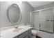 Bathroom featuring a vanity with large mirror, a shower-tub combo, and neutral paint, creating a peaceful aesthetic at 7030 Shep Royster Rd, Oxford, NC 27565