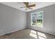 Bright bedroom with large window, ceiling fan, and neutral carpeting providing a cozy retreat at 7030 Shep Royster Rd, Oxford, NC 27565