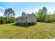 House showcasing a neat backyard, blending indoor-outdoor living in a tranquil, natural environment at 7030 Shep Royster Rd, Oxford, NC 27565