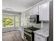 Modern kitchen featuring granite countertops, stainless steel appliances, and a bright window nook at 7030 Shep Royster Rd, Oxford, NC 27565