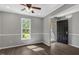 Open concept living area with wood-look floors, a ceiling fan, and a view of the front yard at 7030 Shep Royster Rd, Oxford, NC 27565