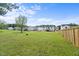 Spacious backyard surrounded by white-fenced properties, perfect for outdoor activities and gatherings in a neighborhood setting at 80 Spotted Bee Way, Youngsville, NC 27596