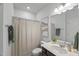 Bathroom with a shower-tub combo with a curtain, vanity with a sink, and a mirror at 80 Spotted Bee Way, Youngsville, NC 27596