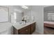 Bathroom featuring double sinks, modern fixtures, neutral walls, and a large mirror at 80 Spotted Bee Way, Youngsville, NC 27596