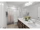 Bathroom featuring double sinks, quartz countertops, and a shower-tub combo with tile surround at 80 Spotted Bee Way, Youngsville, NC 27596
