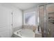 Well-lit bathroom featuring a soaking tub and a separate shower at 80 Spotted Bee Way, Youngsville, NC 27596