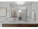 Bright bathroom featuring a double sink vanity, large mirror, and walk-in shower, creating a relaxing atmosphere at 80 Spotted Bee Way, Youngsville, NC 27596
