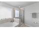 This modern bathroom includes a separate shower and a soaking tub, perfect for relaxation at 80 Spotted Bee Way, Youngsville, NC 27596