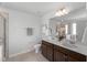 Bright bathroom featuring a double sink vanity, toilet, and walk-in shower, creating a functional space at 80 Spotted Bee Way, Youngsville, NC 27596