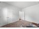 Bedroom with carpet flooring, an armchair, and a closet with doors at 80 Spotted Bee Way, Youngsville, NC 27596