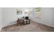 Bedroom with carpet flooring, a chair and stool, a table lamp, and natural light at 80 Spotted Bee Way, Youngsville, NC 27596