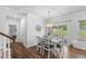 Dining area with slider doors leading outside, a chandelier and lots of natural light at 80 Spotted Bee Way, Youngsville, NC 27596