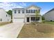 Charming two-story home features a well-maintained lawn, attached garage, and inviting front porch at 80 Spotted Bee Way, Youngsville, NC 27596