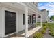 Inviting front porch features seating, decorative touches, and well-maintained landscaping at 80 Spotted Bee Way, Youngsville, NC 27596