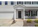 Inviting front porch with seating area, decorative accents, and a charming entrance at 80 Spotted Bee Way, Youngsville, NC 27596