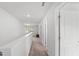 Bright hallway with neutral carpet, leading to bedrooms and featuring natural light from a window at 80 Spotted Bee Way, Youngsville, NC 27596