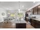 Open kitchen features granite countertops, stainless appliances, and an island with seating and eating area at 80 Spotted Bee Way, Youngsville, NC 27596