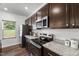 Bright kitchen featuring granite countertops, stainless steel appliances, and modern finishes at 80 Spotted Bee Way, Youngsville, NC 27596