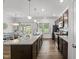 Bright kitchen with granite countertops, an island with seating, stainless appliances and wood floors at 80 Spotted Bee Way, Youngsville, NC 27596
