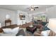 Open-concept living area with plush seating, ceiling fan, and view of the dining area at 80 Spotted Bee Way, Youngsville, NC 27596
