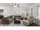 Inviting living room with sectional, decorative pillows, and natural light from the window at 80 Spotted Bee Way, Youngsville, NC 27596