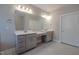 Spacious bathroom with double sinks, a large mirror, and grey cabinets at 800 Gathering Park Cir # 204, Cary, NC 27519