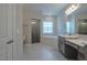 Bathroom showcasing a glass-enclosed shower, separate soaking tub, and double vanity at 800 Gathering Park Cir # 204, Cary, NC 27519
