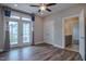 Bedroom with hardwood floors, ceiling fan, and access to a balcony with neighborhood views at 800 Gathering Park Cir # 204, Cary, NC 27519