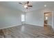 Large bedroom with a ceiling fan, wood floors, and an en-suite bath at 800 Gathering Park Cir # 204, Cary, NC 27519