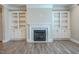 Elegant fireplace with marble surround flanked by custom built-in cabinets at 800 Gathering Park Cir # 204, Cary, NC 27519