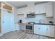 Modern kitchen featuring white cabinets, stainless steel appliances, and subway tile backsplash at 800 Gathering Park Cir # 204, Cary, NC 27519