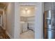 Convenient laundry room with shelving, washer, and dryer adjacent to a modern kitchen at 800 Gathering Park Cir # 204, Cary, NC 27519