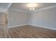 Spacious living room features hardwood floors and chandelier lighting at 800 Gathering Park Cir # 204, Cary, NC 27519