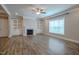 Cozy living room features wood floors and a fireplace with built-in shelving at 800 Gathering Park Cir # 204, Cary, NC 27519