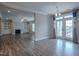 Open-concept living room with hardwood floors, fireplace, built-in shelving, and double doors to the outside at 800 Gathering Park Cir # 204, Cary, NC 27519