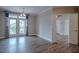 Bright living area with hardwood floors and access to a balcony with views of the neighborhood at 800 Gathering Park Cir # 204, Cary, NC 27519