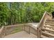 Wooden back deck with stairs leading to the backyard and wooded surroundings at 814 Ellynn Dr, Cary, NC 27511