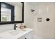 Modern bathroom with a tiled shower, sleek black fixtures, and stylish vanity with a square mirror at 814 Ellynn Dr, Cary, NC 27511