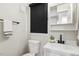 Clean bathroom featuring a sleek vanity with modern fixtures, a toilet, and fresh white paint at 814 Ellynn Dr, Cary, NC 27511