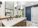 Updated bathroom featuring a double vanity, quartz countertops, and sleek black fixtures, all complemented by stylish tile flooring at 814 Ellynn Dr, Cary, NC 27511
