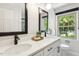 Bright bathroom featuring double sinks, sleek fixtures, and a large window with natural light at 814 Ellynn Dr, Cary, NC 27511