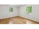 Inviting bedroom with hardwood floors and windows that offer views of mature trees at 814 Ellynn Dr, Cary, NC 27511