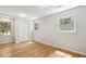 Well-lit bedroom featuring hardwood floors, a closet, and multiple windows providing natural light at 814 Ellynn Dr, Cary, NC 27511
