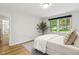 Cozy bedroom featuring a comfortable bed, hardwood floors, and natural light at 814 Ellynn Dr, Cary, NC 27511