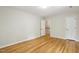 Spacious bedroom with wood floors, neutral walls, and open doorway that provides natural light at 814 Ellynn Dr, Cary, NC 27511