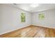 Bright, minimalist bedroom with hardwood floors and two windows offering plenty of natural light at 814 Ellynn Dr, Cary, NC 27511